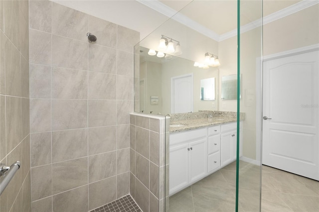 bathroom featuring tile patterned flooring, vanity, tiled shower, and ornamental molding