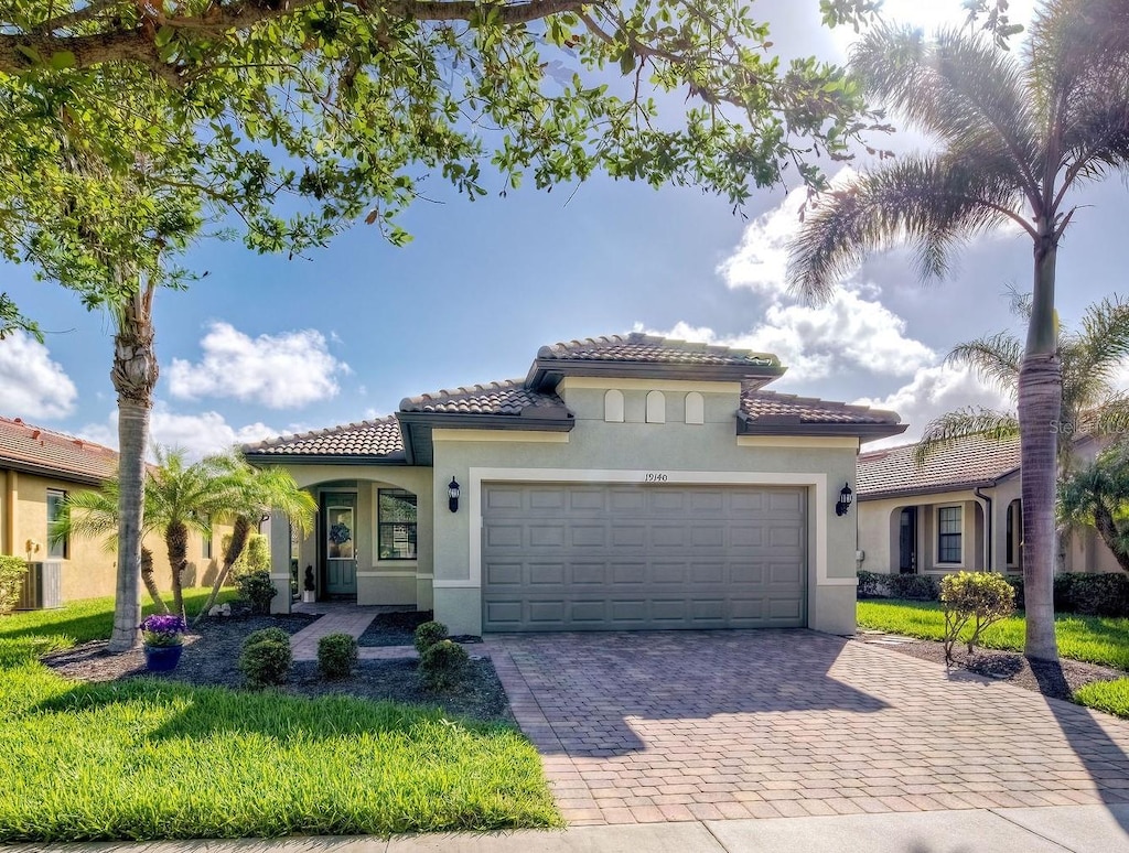 mediterranean / spanish-style house featuring a garage