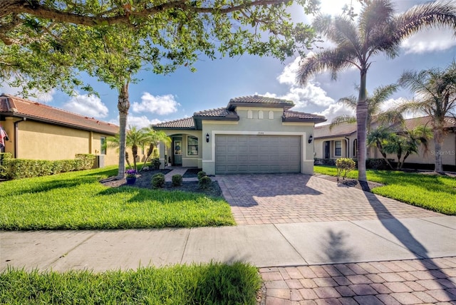 mediterranean / spanish home featuring a garage and a front lawn