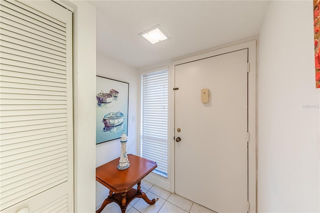 entryway with light tile patterned flooring