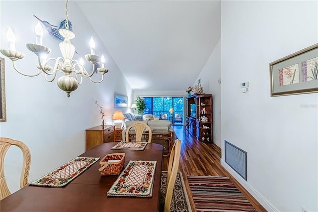 dining space featuring high vaulted ceiling, dark hardwood / wood-style floors, and a notable chandelier