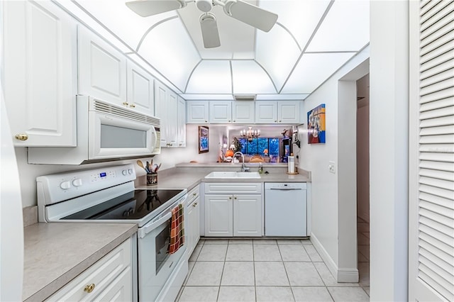 kitchen featuring light tile patterned flooring, white appliances, ceiling fan, and sink