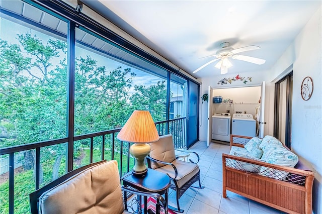 sunroom featuring ceiling fan and separate washer and dryer