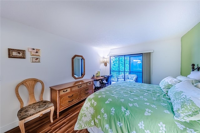 bedroom featuring wood-type flooring and access to outside