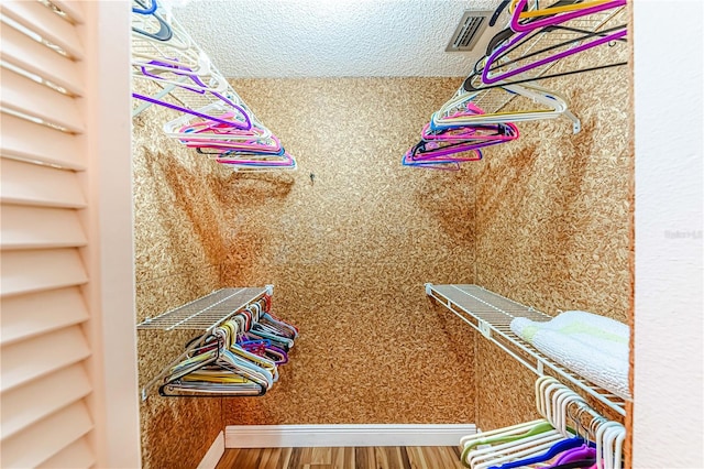 spacious closet featuring hardwood / wood-style flooring