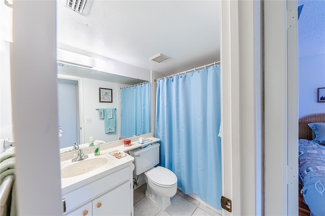 bathroom featuring tile patterned floors, vanity, and toilet