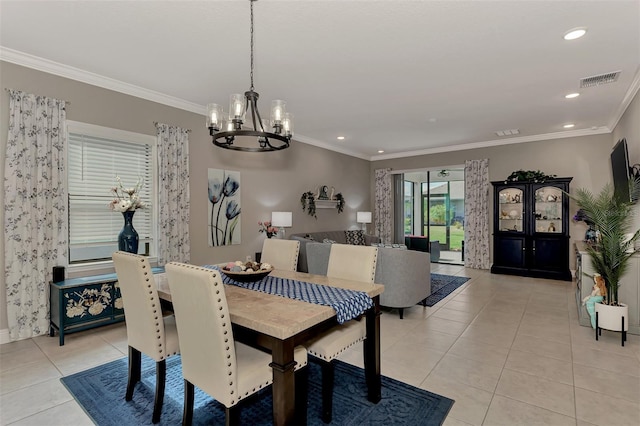 dining area featuring light tile patterned floors, ornamental molding, and a notable chandelier