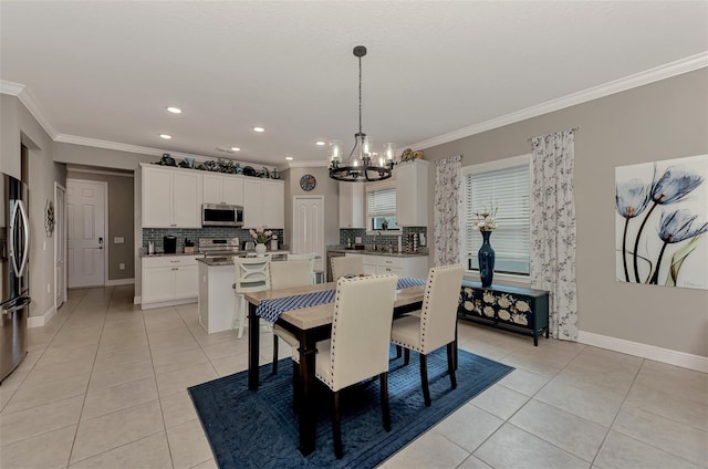 tiled dining room with sink, an inviting chandelier, and ornamental molding