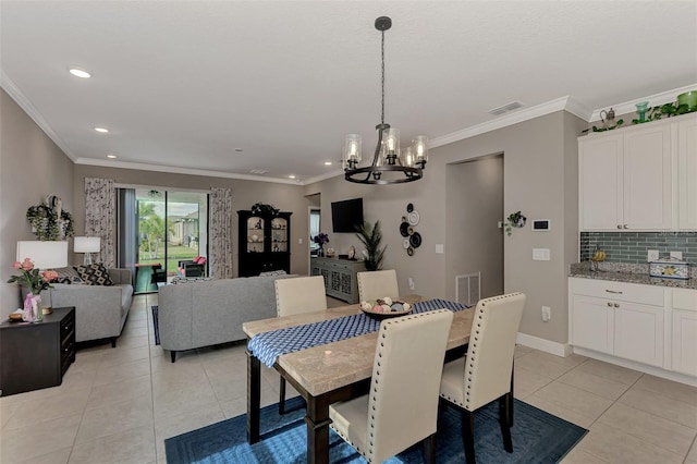 tiled dining area featuring crown molding and a notable chandelier