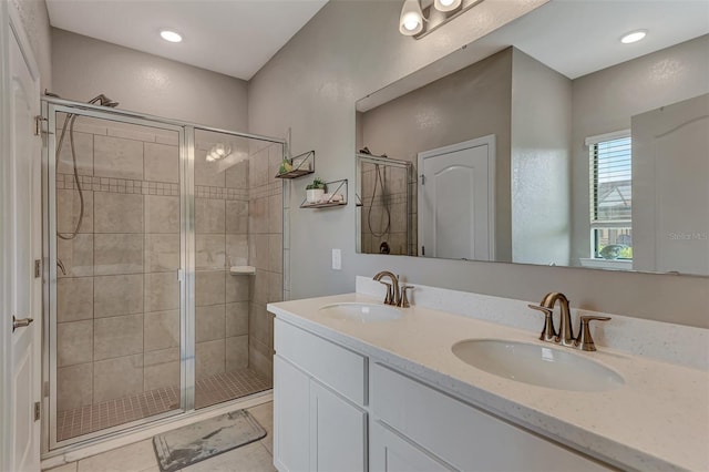 bathroom featuring tile patterned flooring, vanity, and walk in shower