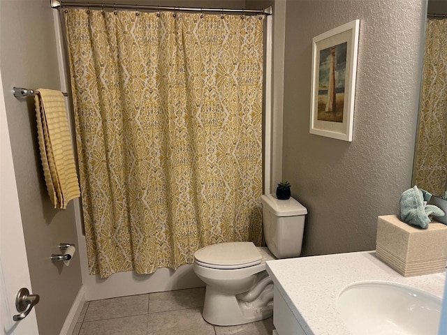 bathroom featuring tile patterned flooring, vanity, and toilet