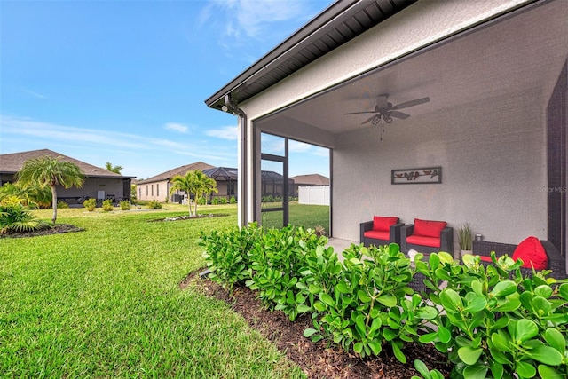 view of yard with ceiling fan