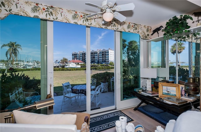 sunroom featuring ceiling fan