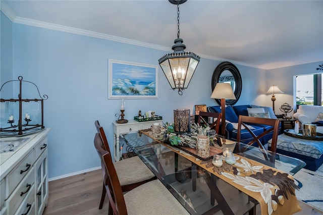 dining room with a chandelier, hardwood / wood-style floors, and ornamental molding