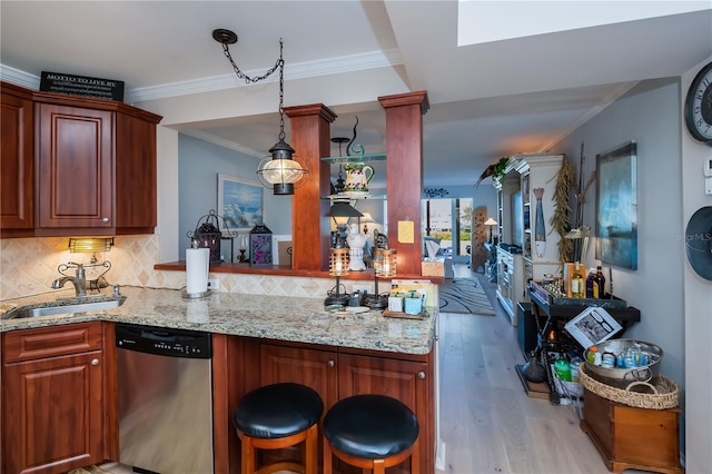 kitchen with kitchen peninsula, tasteful backsplash, stainless steel dishwasher, and sink