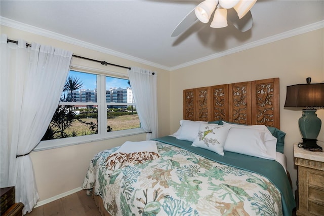 bedroom with ceiling fan, crown molding, and wood-type flooring