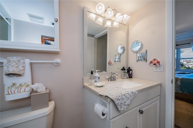 bathroom with vanity and toilet