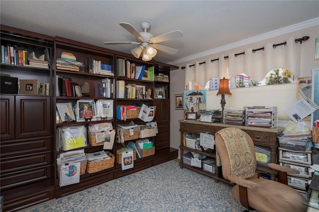 home office featuring ceiling fan, ornamental molding, and a textured ceiling