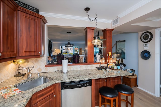 kitchen with dishwasher, hanging light fixtures, kitchen peninsula, light wood-type flooring, and light stone counters