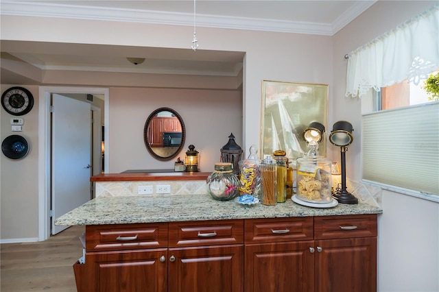 interior space featuring wood-type flooring, light stone countertops, and crown molding