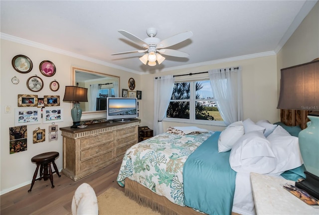 bedroom with ornamental molding, ceiling fan, and light hardwood / wood-style flooring