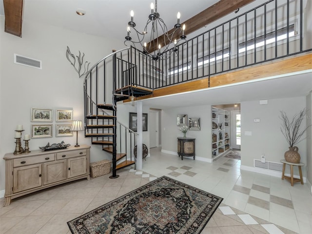 1141 Sleepy Hollow Ct, Venice, FL 34285 - stairs featuring a high ceiling, baseboards, a chandelier, and tile patterned flooring