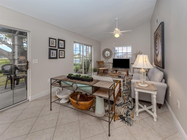 tiled living room featuring ceiling fan and lofted ceiling