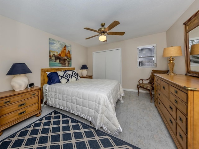 1141 Sleepy Hollow Ct, Venice, FL 34285 - bedroom featuring light wood-style floors, a closet, baseboards, and a ceiling fan