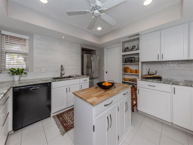 1141 Sleepy Hollow Ct, Venice, FL 34285 - kitchen with black dishwasher, stainless steel fridge, a sink, light tile patterned floors, and recessed lighting