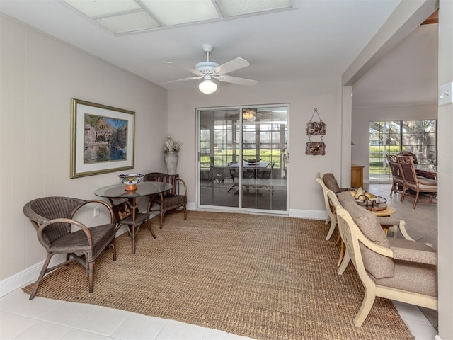 living area with ceiling fan and light tile patterned floors