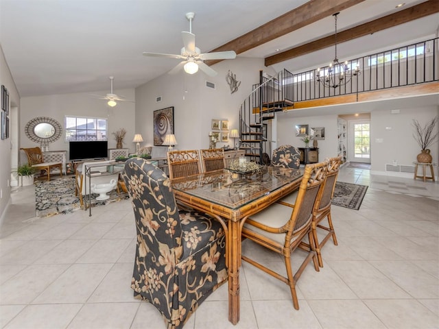 dining space with light tile patterned flooring, a healthy amount of sunlight, ceiling fan with notable chandelier, and high vaulted ceiling