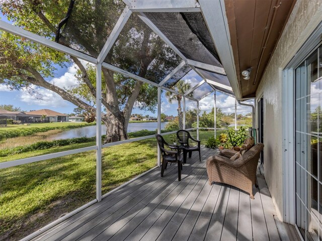 unfurnished sunroom featuring a water view and lofted ceiling