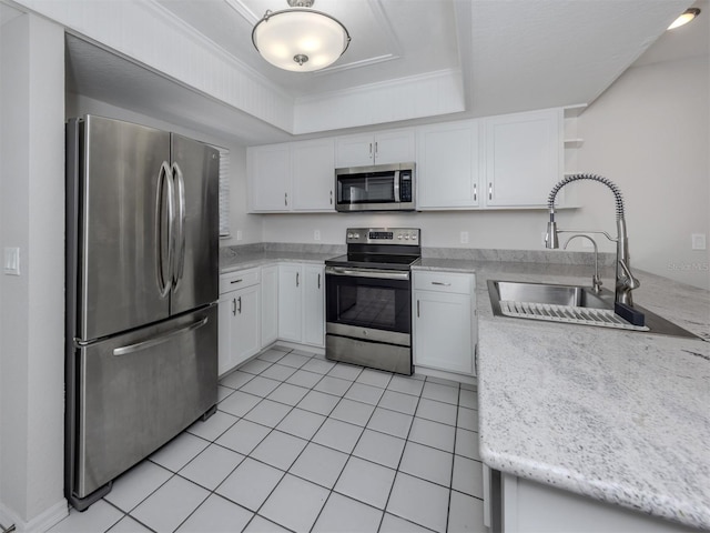 kitchen featuring white cabinetry, sink, light tile patterned floors, and appliances with stainless steel finishes