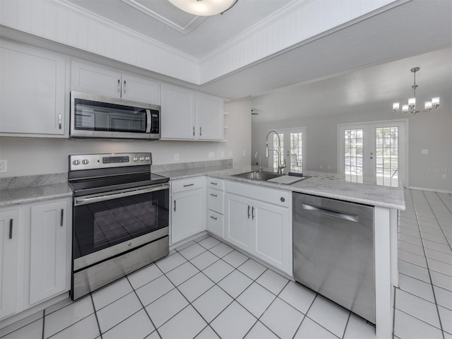 kitchen featuring kitchen peninsula, french doors, white cabinets, and stainless steel appliances