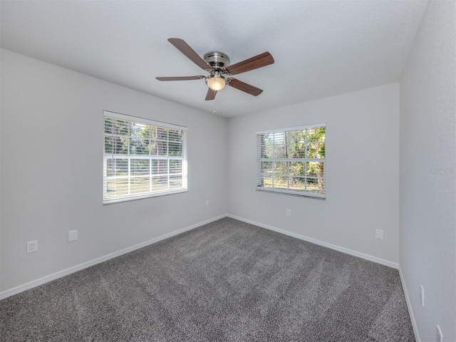 unfurnished room featuring carpet, ceiling fan, and a healthy amount of sunlight