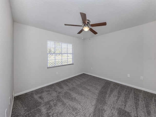 carpeted empty room with ceiling fan and a textured ceiling