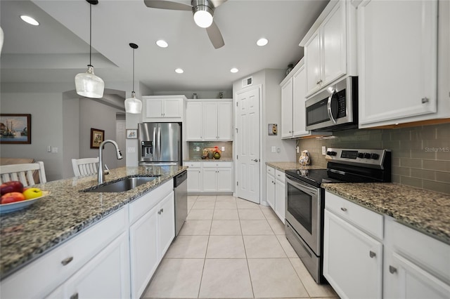 kitchen with white cabinets, dark stone countertops, sink, and appliances with stainless steel finishes