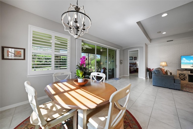 tiled dining space featuring a wealth of natural light and a chandelier