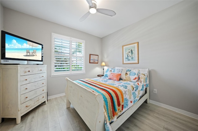 bedroom with ceiling fan and wood-type flooring