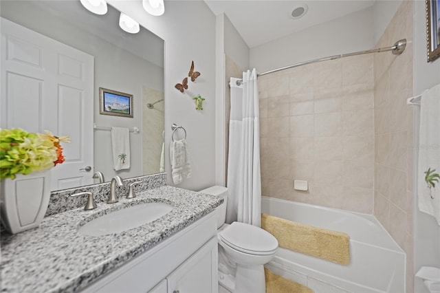 full bathroom featuring shower / bath combo, vanity, and toilet