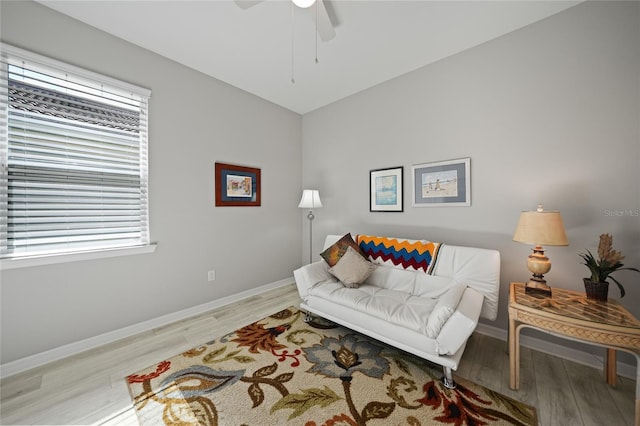 living room with ceiling fan and light wood-type flooring