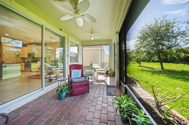 sunroom featuring ceiling fan