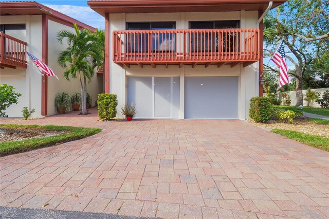 rear view of property featuring stucco siding and a balcony