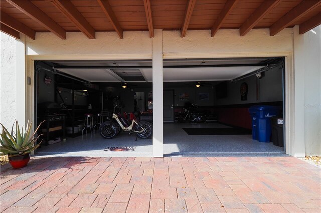 garage with decorative driveway