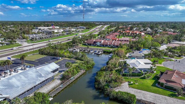 birds eye view of property with a water view and a residential view