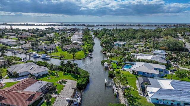 drone / aerial view featuring a residential view and a water view