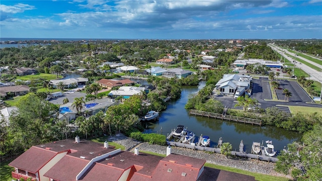 drone / aerial view with a water view and a residential view