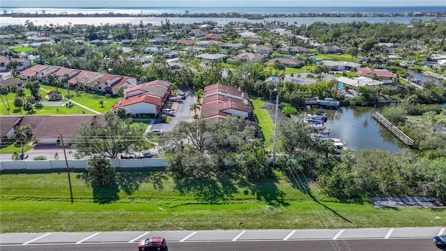 birds eye view of property with a water view and a residential view