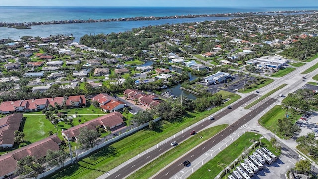 drone / aerial view with a residential view and a water view