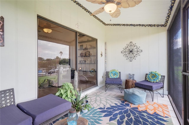 sunroom / solarium featuring a ceiling fan